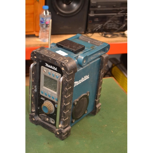 291 - Makita radio with battery and charger, appears in full working order