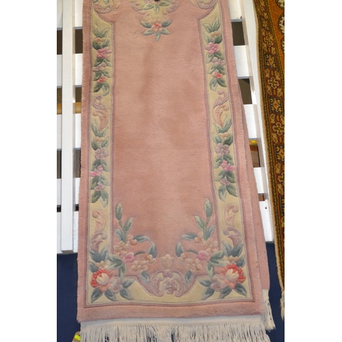 709 - Pink Chinese carpet runner with floral border: 69cm x 320cm approx