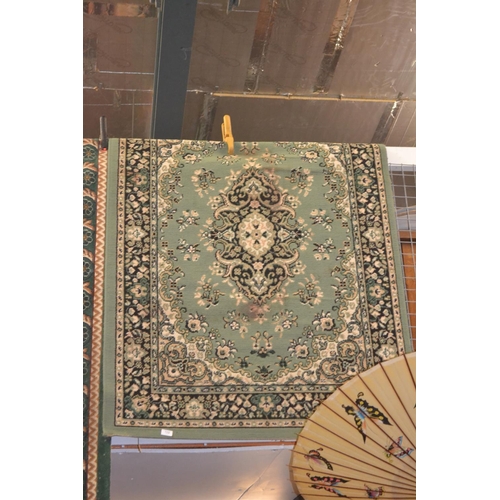 713 - Green Belgian rug with central medallion and border 117cm x 160cm