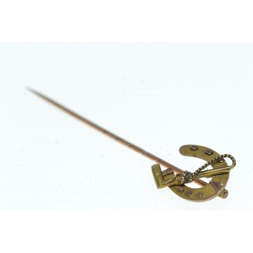 62 - 9ct gold horse shoe & crop stick pin, 1.24 grams