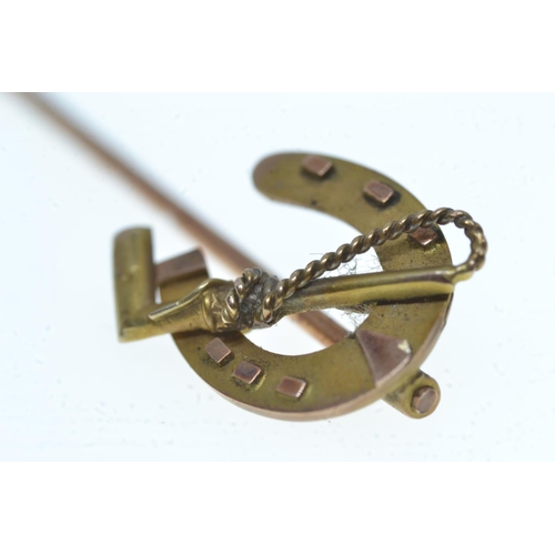 62 - 9ct gold horse shoe & crop stick pin, 1.24 grams
