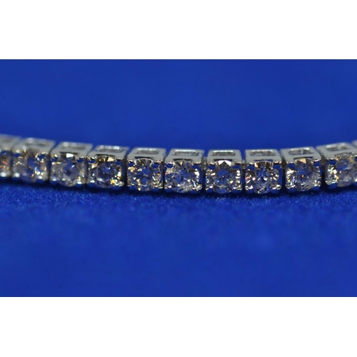 86 - 18ct white gold & 3ct diamond line bracelet, circumference 175mm, 8.13 grams