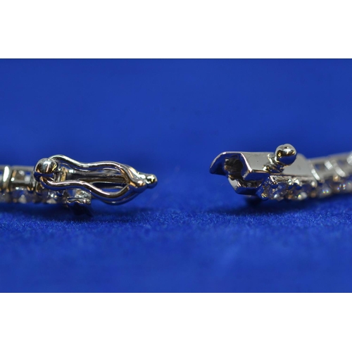 86 - 18ct white gold & 3ct diamond line bracelet, circumference 175mm, 8.13 grams