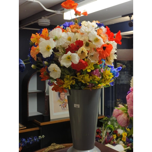 726 - Grey vase of artificial flowers.