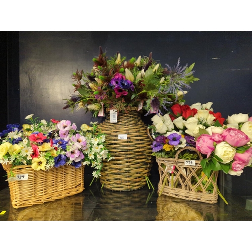 729 - 3 wicker containers of flowers.