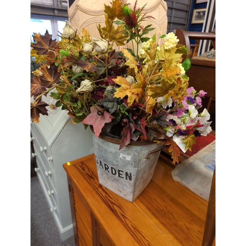 730 - Galvanised bucket full of autumnal and silk flowers.