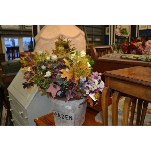 730 - Galvanised bucket full of autumnal and silk flowers.