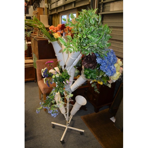 735 - Display rack of silk flowers.