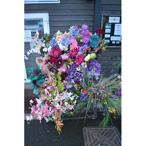 736 - Large quantity of silk flowers on rack including 8 buckets. (Rack not included).