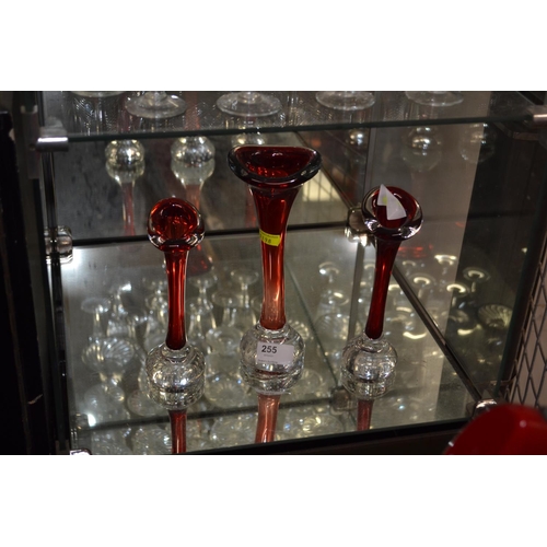 255 - 3 graduated red glass stem vases, with captive bubble bases