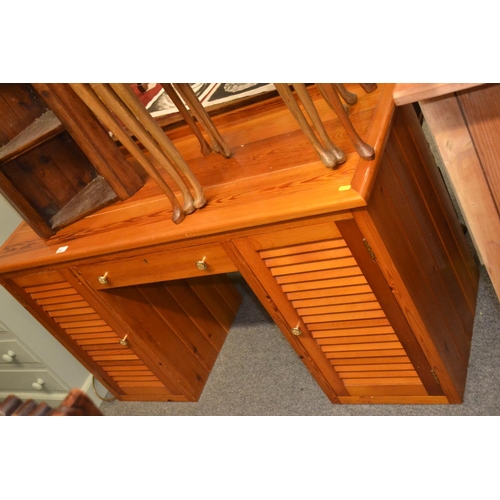 550 - Pine desk, with central drawer, flanked by louvred doors opening to reveal 2 drawers and lower stora... 