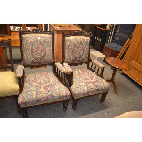 559 - Pair of carved back & upholstered arm chairs, raised on castors. w66cm d68cm h104cm