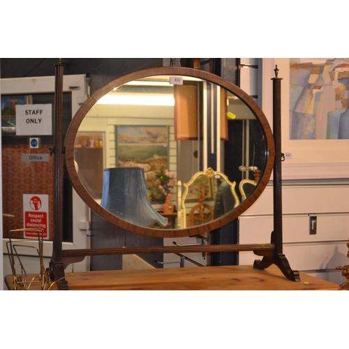 453 - Mahogany oval swing mirror. 70cm wide x 60cm high