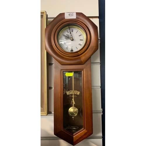 452 - Regulator A wall clock with pendulum and key, height 45cm