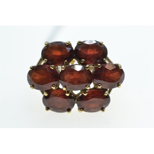 63 - 9ct gold & garnet cluster ring, size R, 5.27 grams