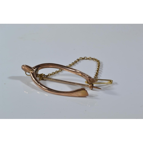 66 - 9ct gold wishbone brooch & a 9ct gold bracelet with horseshoe clasp, gross weight 5.1 grams