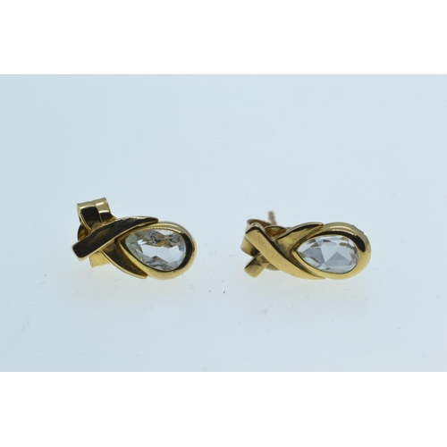 133 - Two pairs of 9ct gold ear studs, one set with topaz, the other designed as a tri-colour gold knot, g... 