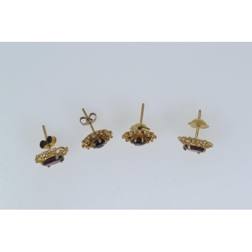 143 - Two pairs of 9ct gold & garnet ear studs, gross weight 3.75 grams