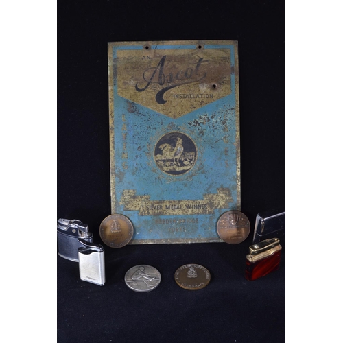 217 - 'Ascot Installation' silver medal winner enamel sign, four cigarette lighters & various medallio... 