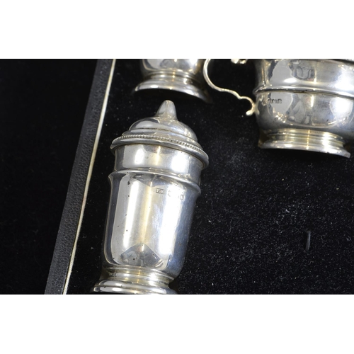 253 - Cased silver cruet set, maker EV, Sheffield 1940, comprising pair of pepperettes, pair of salt shake... 