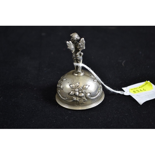 264 - Continental silver table bell with cherub finial, with import marks, height 7cm, 63.92 grams