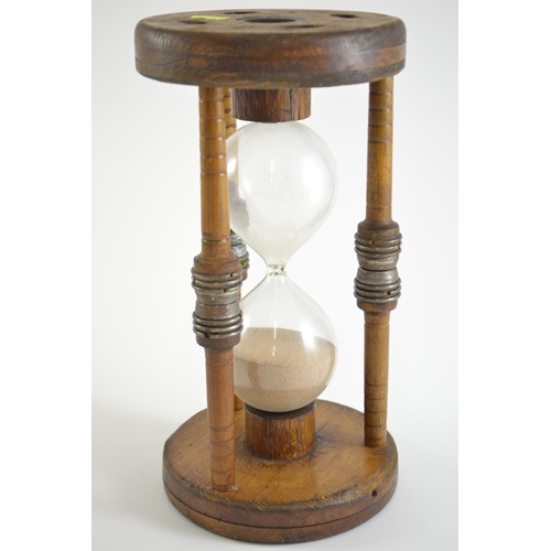 392 - Large hourglass, mounted in oak. 30cm high x 16cm diameter of top & base