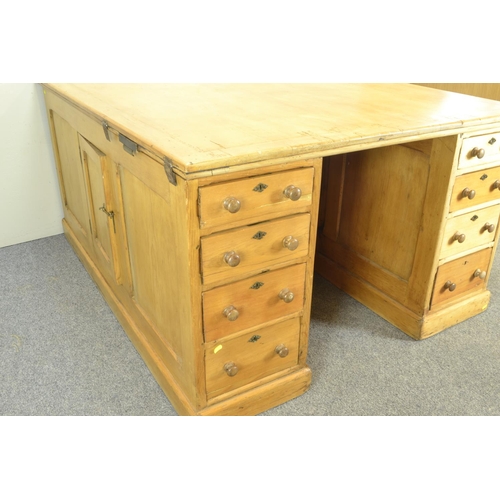 456 - Early C20 pine partners desk. With 8 drawers to each side, and side cabinet. w121cm L152cm h76cm