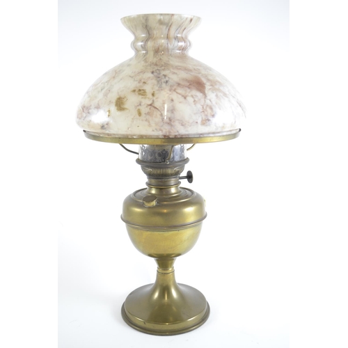 404 - Paraffin lamp with brass base and marbled glass shade. Height 47cm