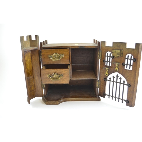 409 - Unusual castle smokers cabinet. Reg No. 18593235. Width 27cm x height 30cm x depth 18cm.