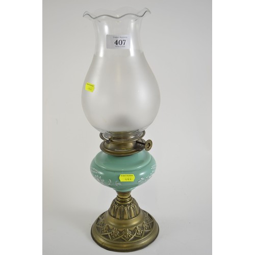 407 - Art Nouveau lamp with green glass reservoir and brass base.