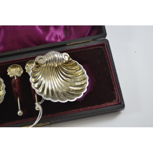 267 - Cased pair of late Victorian silver scallop-shaped salts & spoons, maker WA, Chester 1899, gross... 