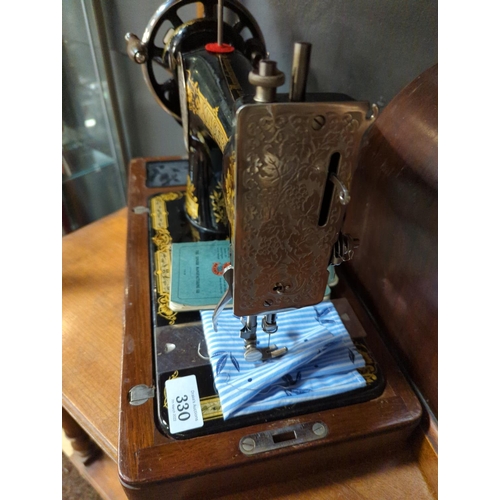 330 - Singer sewing machine No.28 in case with accessories.