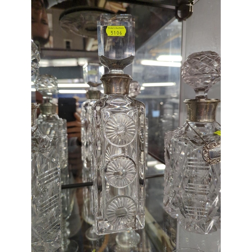 365 - 3 cut glass decanters with silver collars.