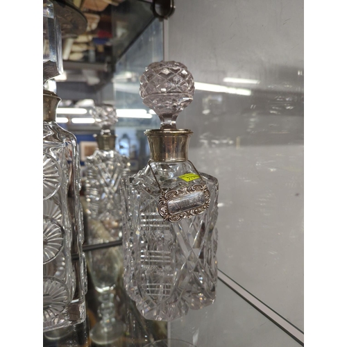 365 - 3 cut glass decanters with silver collars.