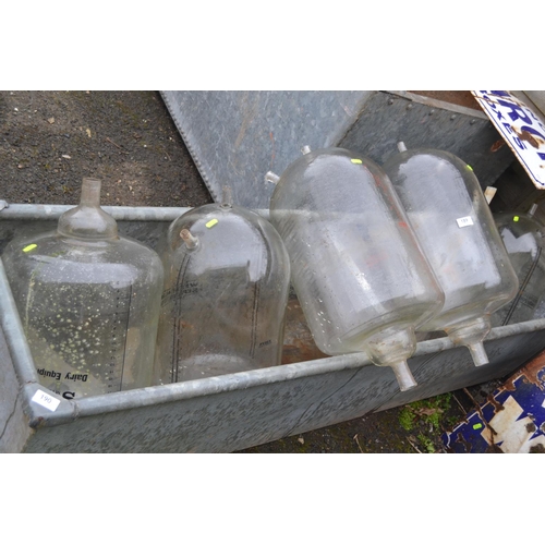 189 - 6 glass milking jars. L64cm