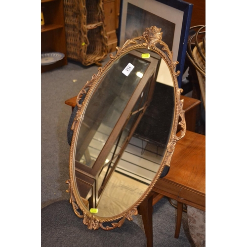 416 - Oval gilt mirror with metal frame. W39cm H66cm.&nbsp;