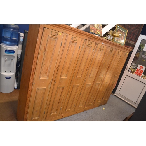 558 - Striped pine locker unit comprising of 7 locker/cupboards W229.5cm D32cm H155cm. Individual cupboard... 