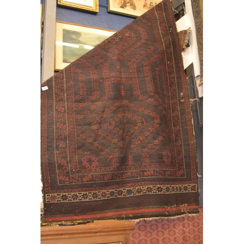 631 - worn eastern rug with various holes. 206.5cm X 110cm.