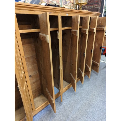 558 - Striped pine locker unit comprising of 7 locker/cupboards W229.5cm D32cm H155cm. Individual cupboard... 