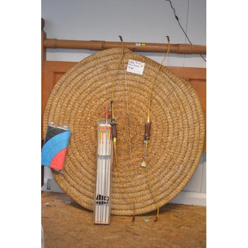 125 - 128cm round Straw archery target with 2 bows and a box of arrows.