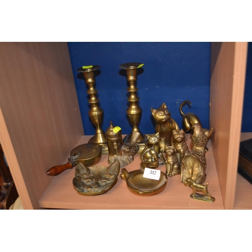 312 - Shelf of brassware, mostly brass cats.