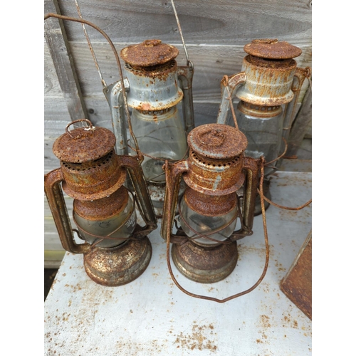 15 - 2 vintage petrol cans, 1 with pratts lid, & 4 hurricane lanterns