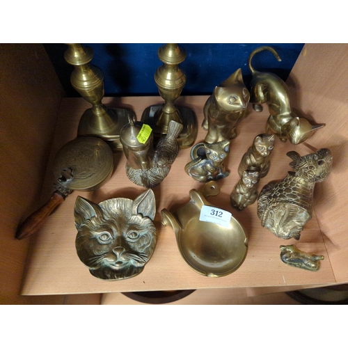 312 - Shelf of brassware, mostly brass cats.