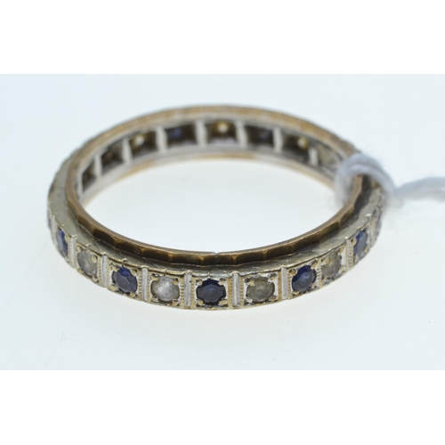 63 - Eternity ring set with blue & white gemstones, the mount testing positive for platinum & 18c... 