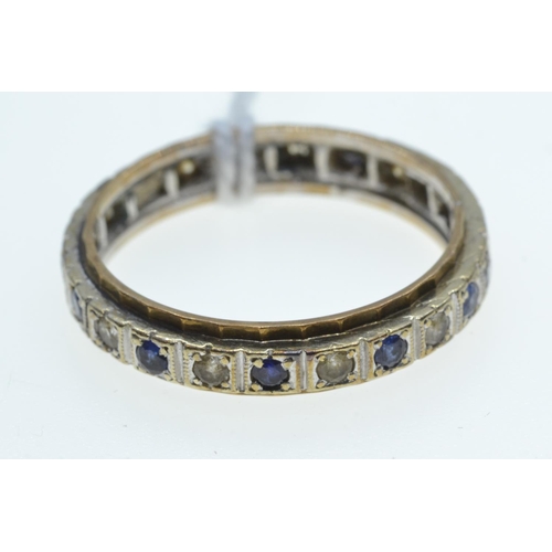 63 - Eternity ring set with blue & white gemstones, the mount testing positive for platinum & 18c... 