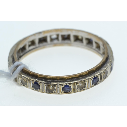 63 - Eternity ring set with blue & white gemstones, the mount testing positive for platinum & 18c... 