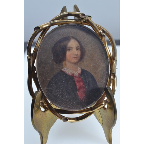 82 - Yellow metal framed reversible mourning brooch, with portrait miniature to one side & arrangemen... 