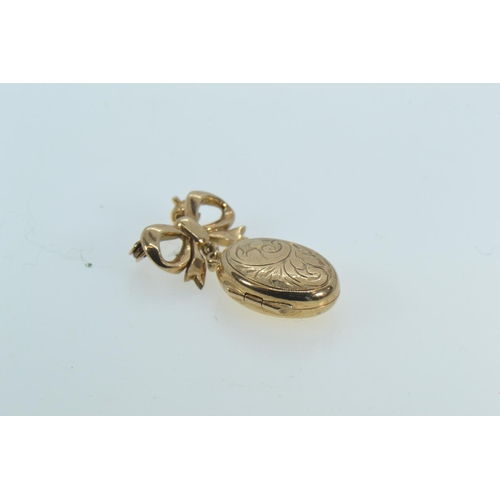 91 - 9ct gold locket pendant with ribbon surmount, length 30mm, 3.9 grams