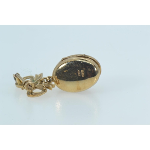 91 - 9ct gold locket pendant with ribbon surmount, length 30mm, 3.9 grams