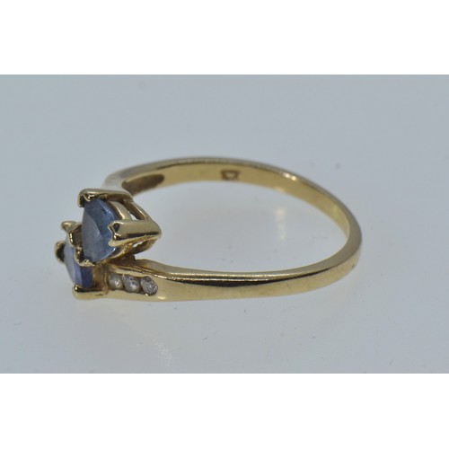 2 - 10ct gold crossover ring set with blue & clear stones, size N, 2 grams